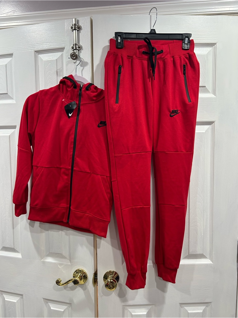 Kids red zip-up Nike sweat suit